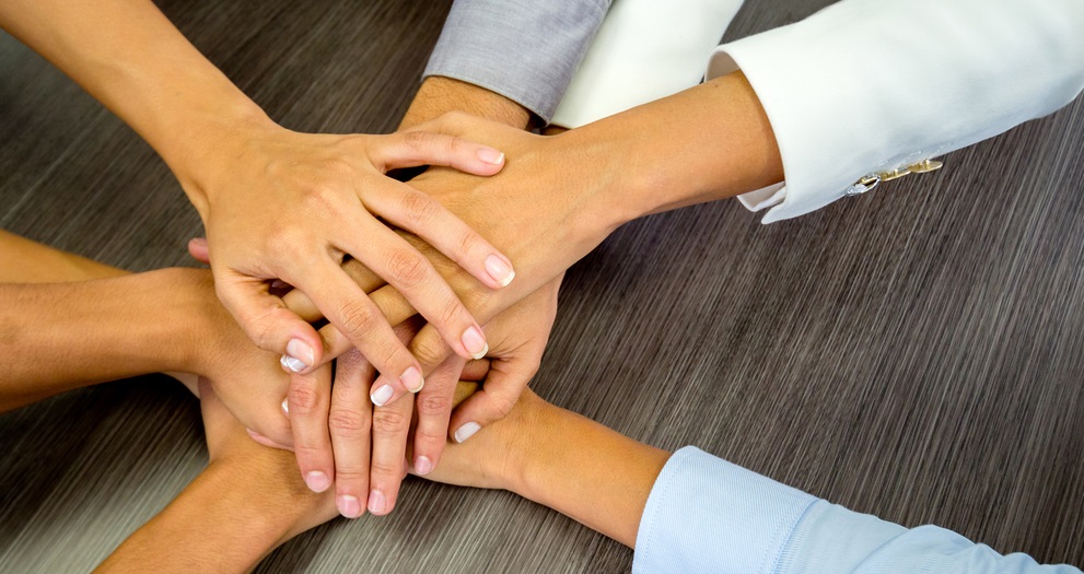 Business team in a meeting with their hands together
