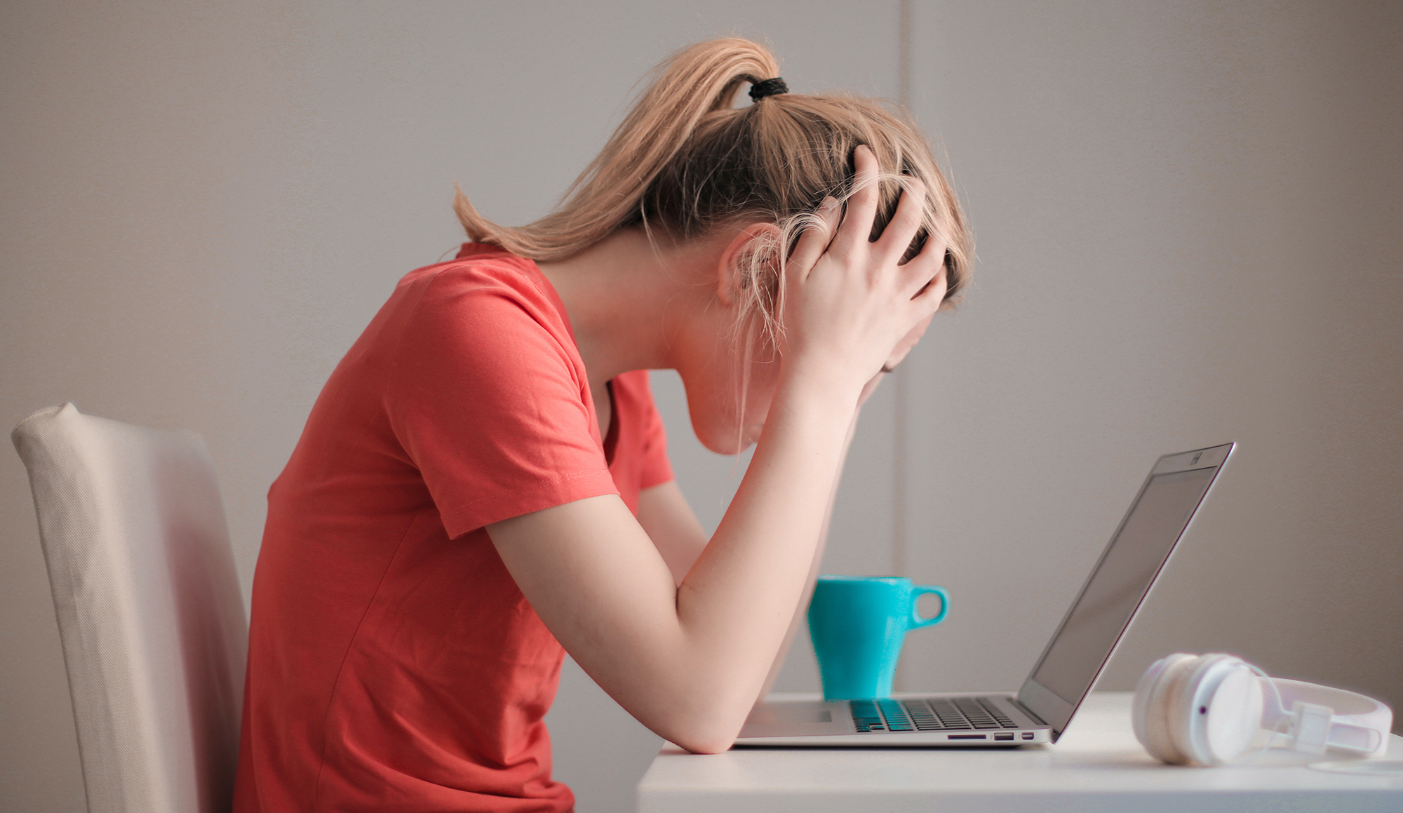 woman-in-red-t-shirt-looking-at-her-laptop-3755761